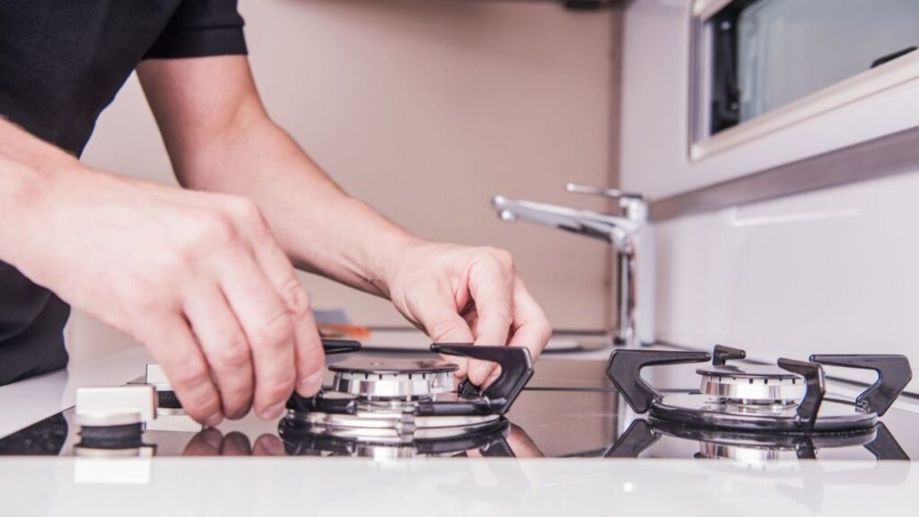 Mobile RV appliance technician servicing fridge at Charlotte campsite